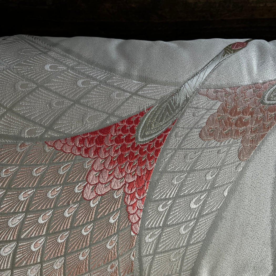 Detailed close-up of embroidery design on Peach Cranes Handmade silk bolder cushion.