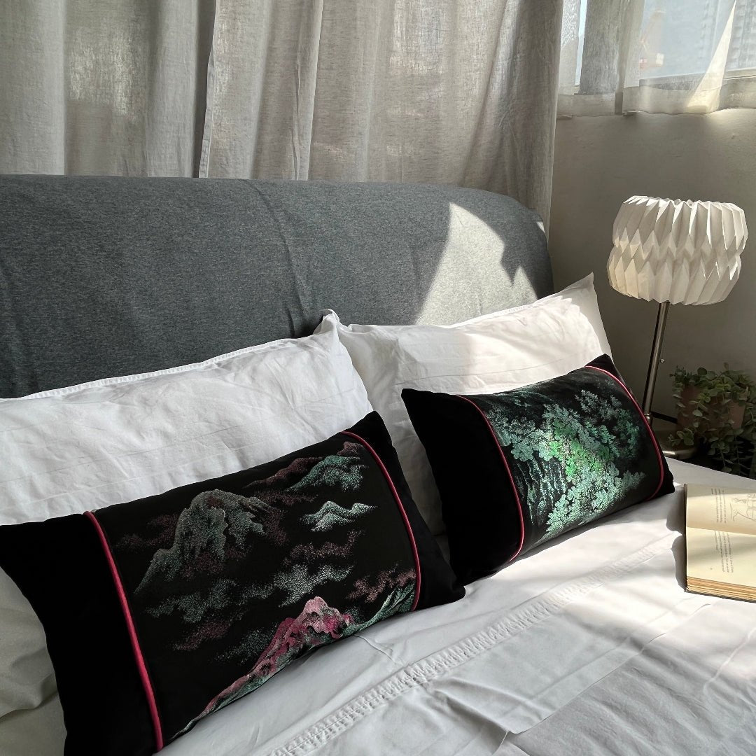 Pair of kimono cushion displayed on mock-up bed. Black Silk and velvet with pink and green metallic woven design