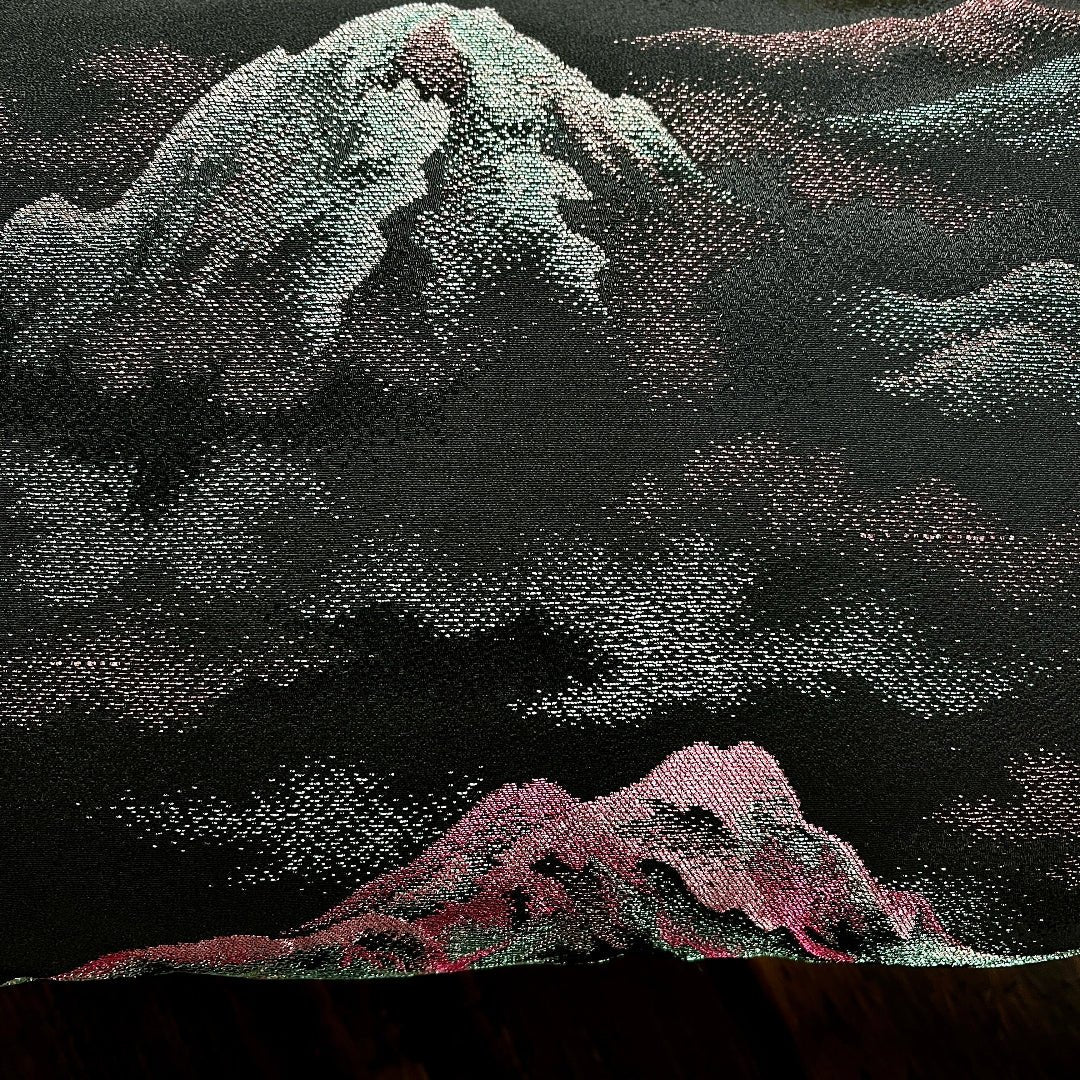 Close look at woven metallic design on black silk kimono cushion