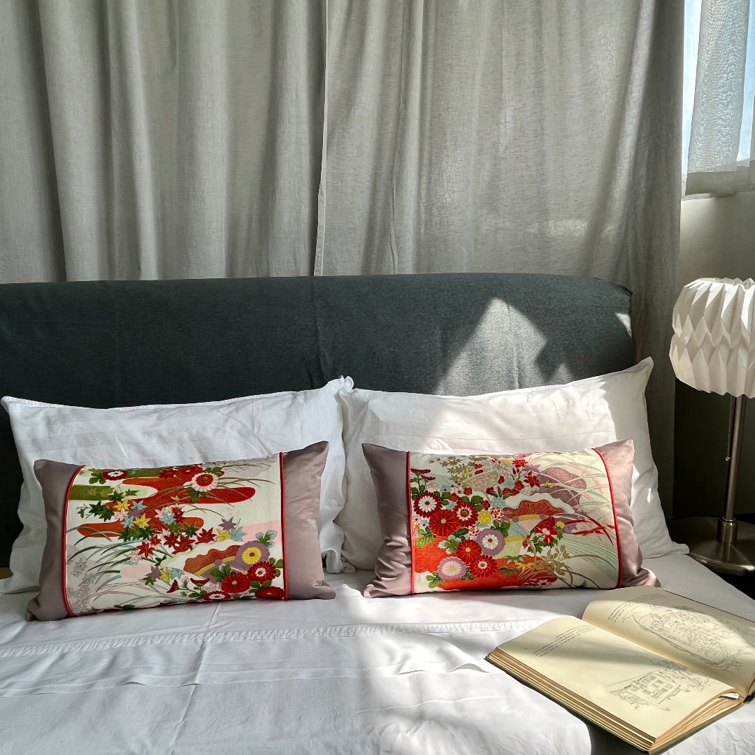Pair of sustainable silk kimono cushion on bed. Hand painted silk with lilac side and back panels.