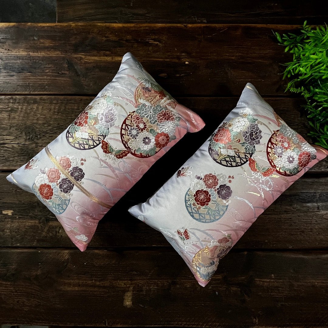 Pink to violet ombre silk Obi cushions depicting butterflies and flowers symbolic of transformation and new beginnings.