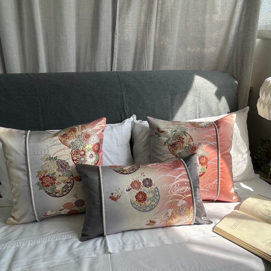 Set of silk Obi cushions on bed, with Butterfly and flower motifs representing transformation and new beginnings.