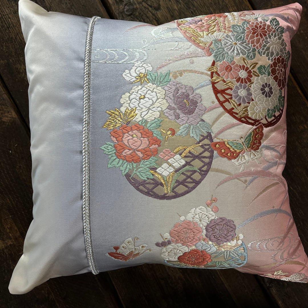 Silk cushion with Butterfly and flower motifs representing transformation and new beginnings.